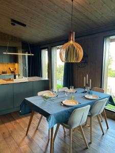 a dining room with a blue table with chairs at Modern Cabin By The Ski Trails At Fagerhøy in Sør-Fron +29 photos