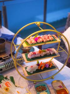 a table with three plates of food on a table at Cheevavavee Doichang Chiangrai in Ban San Pu Loei +35 photos