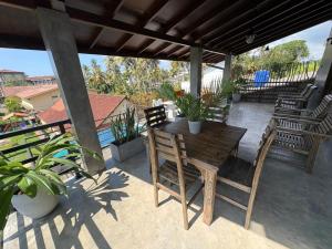 a wooden table and chairs on a patio at Villa DEE DEE & Wellness in Galle