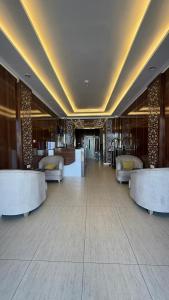 a lobby with couches and tables in a building at Distinctive Palace - القصصر المميز للشقق المفروشه in Abha