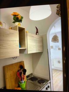 a kitchen with wooden cabinets and a counter top at A casa di Giulia in Filettino Graziani +5 photos