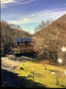 a house on a hill with trees and a street at A casa di Giulia in Filettino Graziani