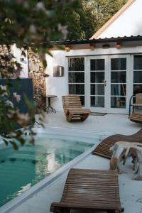 a house with a swimming pool and a bench at Usedlost Ledňáček - Boutique Wellness & SPA in Písečné