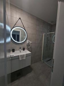 a bathroom with a sink and a mirror at Pansion Kod Brajlovica in Tuzla