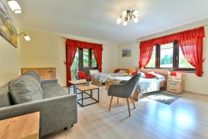 a living room with two beds and a couch at Dom Gościnny Efka in Kościelisko