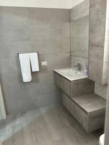 a bathroom with a sink and a mirror at BALISTRERI HOUSe in Trabia