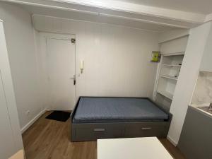 a small bedroom with a bed in a room at Le petit Rouennais in Rouen