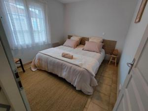 Ένα ή περισσότερα κρεβάτια σε δωμάτιο στο Les Iles d'ici