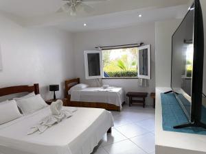 TV a/nebo společenská místnost v ubytování Pousada Caminho da Praia