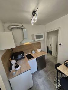 a kitchen with a sink and a counter top at Cocon en vieille ville in Nancy