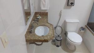 a small bathroom with a toilet and a sink at Pousada da Serrinha in Mariana