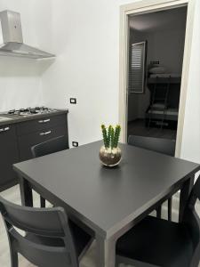 a dining room table with a potted plant on it at BALISTRERI HOUSe in Trabia