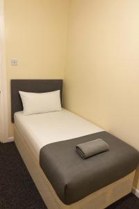 a bedroom with a bed with a pillow on it at 3-Bed Home, Free Parking, Smart TV,Family & Business Ready in Slough