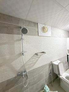 a shower in a bathroom with a sink and a toilet at Eileen wadi rum camp in Wadi Rum