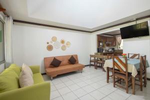 a living room with a couch and a table at Casa del Sol - Poolside Villa in Quepos