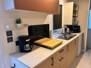 a kitchen with a counter with a coffee maker on it at Tinyhouse 6 Ferienwohnung Mobilheim Fehmarn in Fehmarn