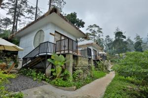 a house on the side of a mountain at The Full Hot Spring & Resort in Kemloko-gede