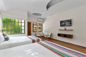 Ένα ή περισσότερα κρεβάτια σε δωμάτιο στο Casa Quinta Luna Guest house Near to Cancun air port +17 φωτογραφίες