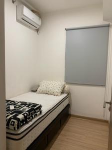 a small room with a bed and a window at Sky House BSD D2-3A - 3 Bedroom Type in Samporo
