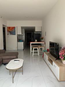a living room with a couch and a table at Sky House BSD D2-3A - 3 Bedroom Type in Samporo