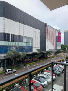 a parking lot with cars parked in front of a building at Sky House BSD D2-3A - 3 Bedroom Type in Samporo