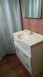 een badkamer met een wastafel en een spiegel bij LAPOSTa555 in Piriápolis +7 foto's