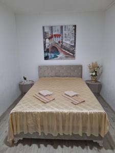 a bed with two napkins on it in a room at Ris kuca za odmor in Foča