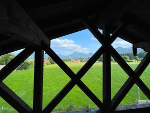 a view from a window of a field at Gemütliche Ferienwohnung im DG am Tegernsee - Bergblick, Ruhe & ganz viel Platz in Bad Wiessee