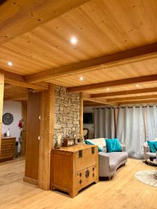 a living room with a couch and a wooden ceiling at Chalet Beaufort in Saint-Martin-de-Belleville +58 photos