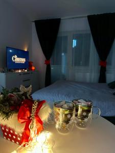 a table with christmas decorations and lights on a bed at Romantic studio AxS in Floreşti