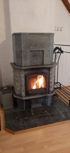 einen Kamin in einem Zimmer mit Kamin in der Unterkunft Ferienwohnung KIostermühle Irsee - Parkplätze, Spielplatz, Biergarten, Badesee, E-Auto Ladepunkt in Irsee + 68 Fotos