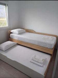 two bunk beds in a room with a window at Mare Resort Maggana in Xanthi +12 photos