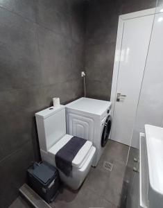 a bathroom with a white toilet and a sink at Mare Resort Maggana in Xanthi