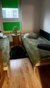 a bedroom with two beds and a table with a lamp at Leśna Przystań Rumia - obok Gdyni i Aquaparku Reda in Rumia +88 photos