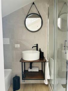 a bathroom with a sink and a mirror on the wall at Urban Nest in Milan