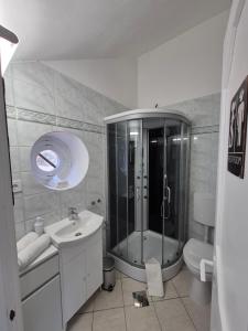 Un baño con ducha, lavabo e inodoro. en Red Lion Pub & Apartments Szentendre, en Szentendre 55 fotos más