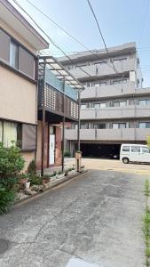 an empty parking lot in front of a building at aiki home in Tokyo