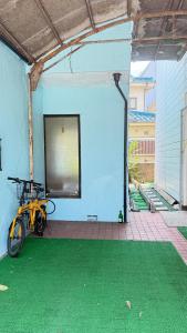 a bike parked in a room with a blue wall at aiki home in Tokyo