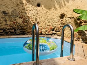 a swimming pool with two bowls on top of it at Les chambres d'Ursule in Tartas