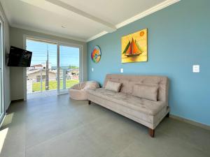 Apê Alegria - Capri Morada & Mar - Frente mar في ساو فرانسيسكو دو سول: غرفة معيشة مع أريكة وتلفزيون