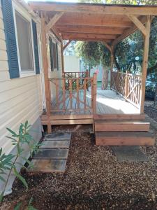 een houten pergola aan de zijkant van een huis bij Glamour Pakoštane Mobile Home in Pakoštane