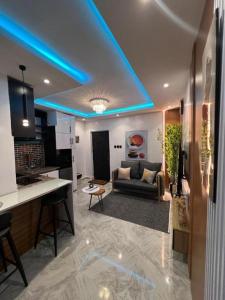 a living room with a couch and a blue ceiling at Hertz Studio in Lagos +3 photos