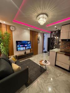 a living room with a couch and a tv at Hertz Studio in Lagos