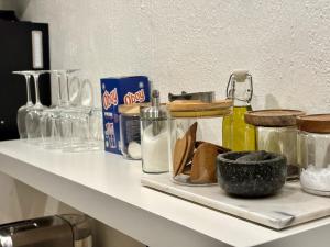 a shelf with condiments on top of a counter at Sundsvall By M - Basement Studio in Sundsvall