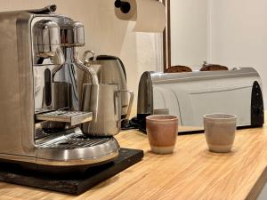 a coffee maker sitting on a counter next to a microwave at Sundsvall By M - Basement Studio in Sundsvall