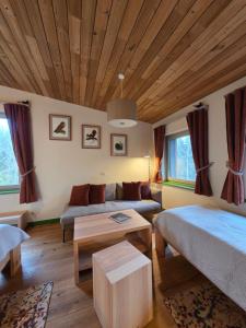 a living room with a couch and a table at Gintarautojai in Palanga