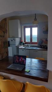 a kitchen with a table with a laptop on it at Casa Zia Maria 6 posti Monterosso Coast to Coast in Monterosso