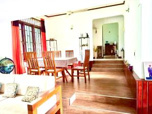 a dining room with a table and chairs at House 123 in Nikawatawana