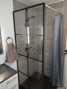 a shower with a glass door in a bathroom at BnB Hammerum in Herning