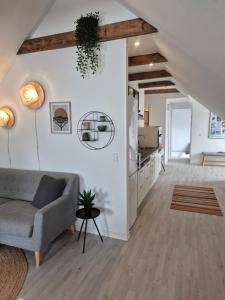 a living room with a couch and a kitchen at BnB Hammerum in Herning